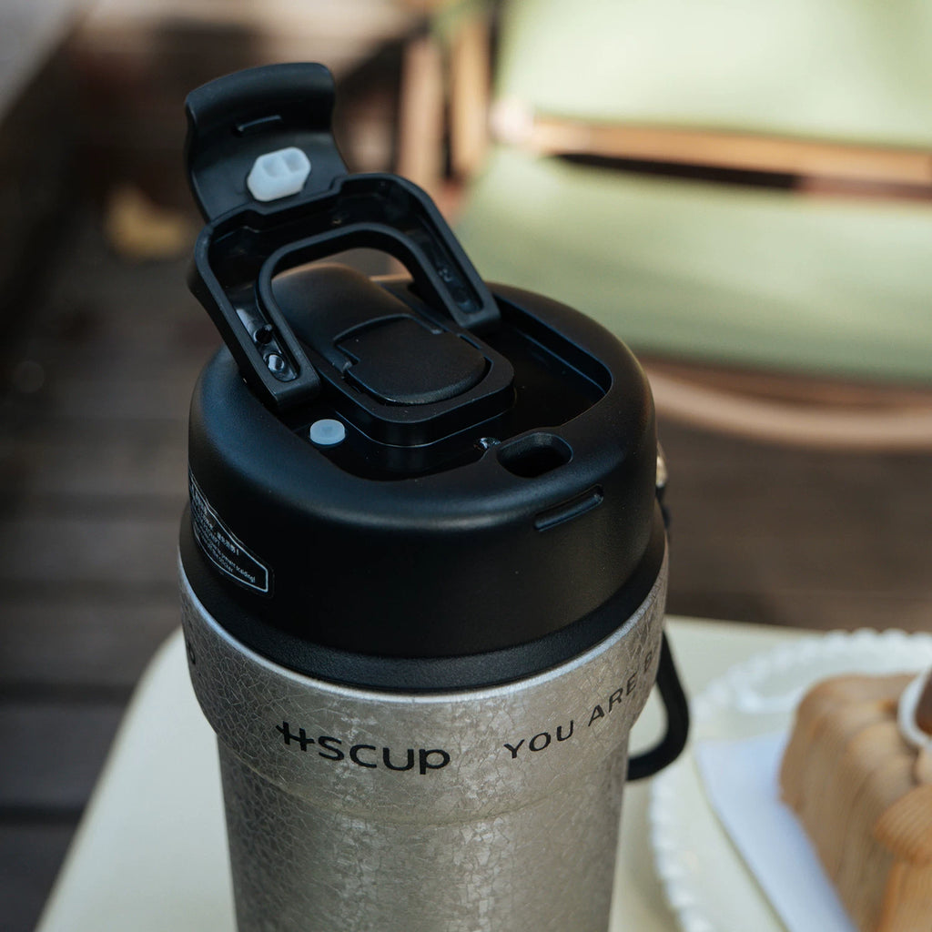 Wookoo cat tumbler, 304 stainless steel coffee cup with carry lanyard, worn view