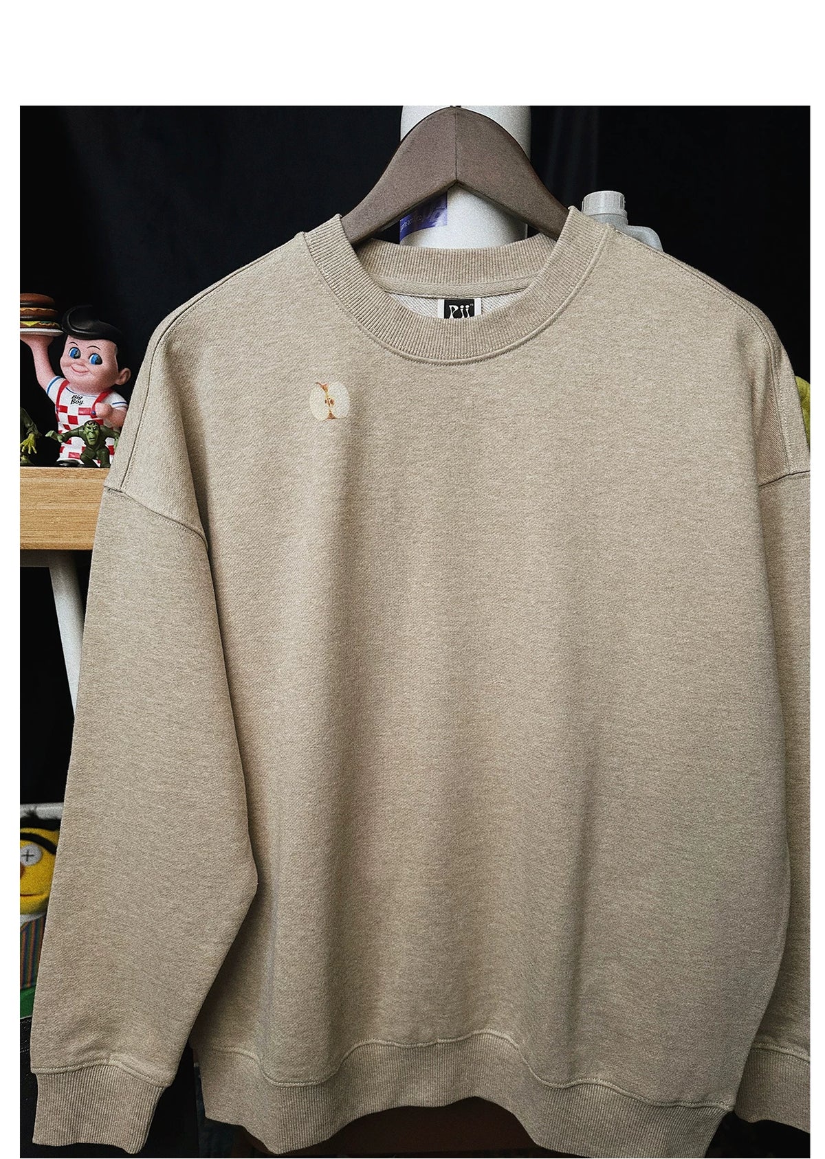 Pixel apple embroidered hoodie, close-up