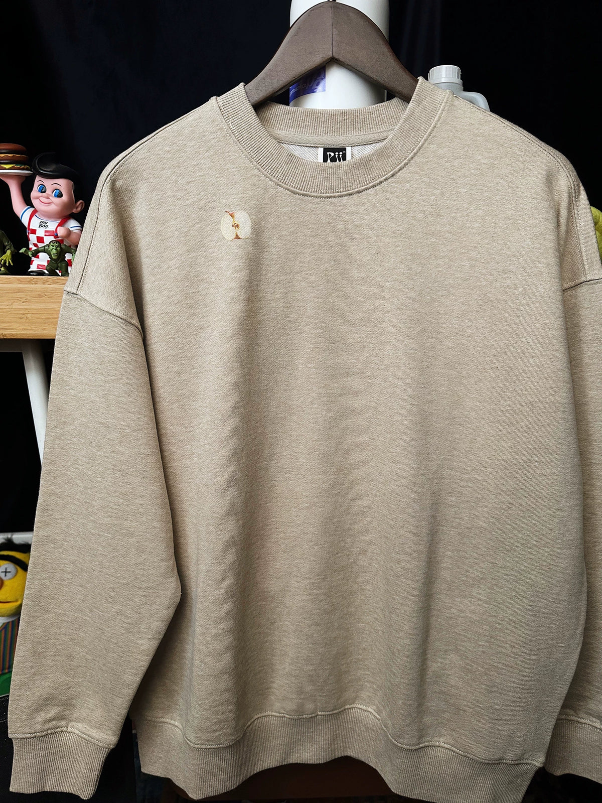 Pixel apple embroidered hoodie, flat lay