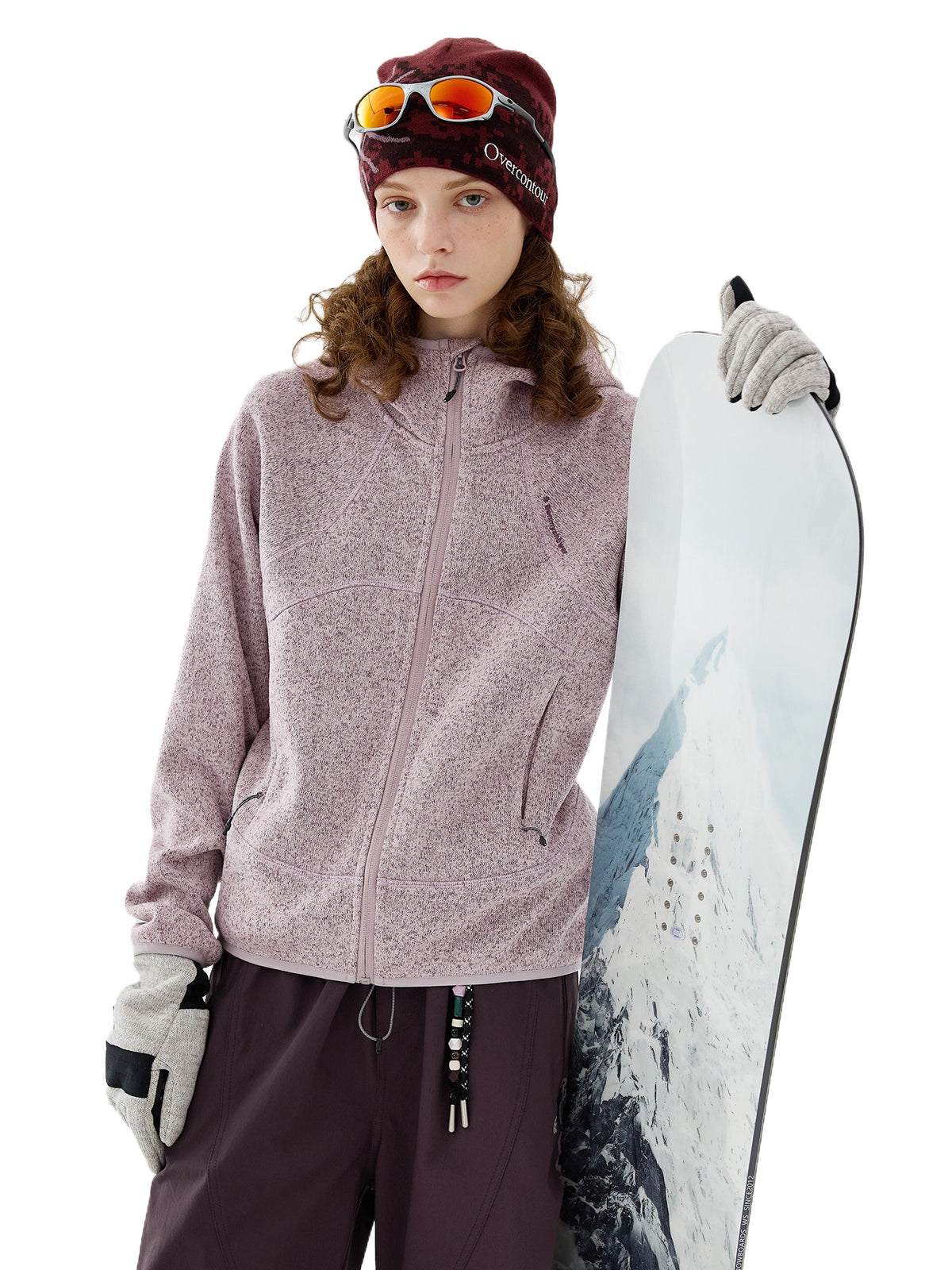 Model wearing pink full-zip melange knit fleece jacket holding a snowboard